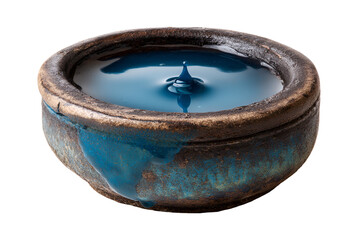 A clay pot filled with a vibrant blue liquid