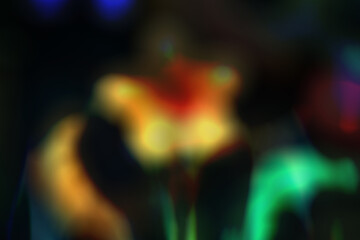 Bokeh effect on yellow and orange flowers, creating a soft focus and an artistic, blurred light atmosphere.