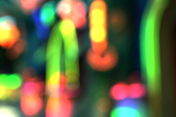 A close-up detail of blurred neon lights or bright reflections, showcasing strong neon lines and colors.