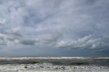 Mediterranean Beach at Tore del lago Puccini. Autumn sky with little sun. Reflections in water.