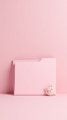 A cat figurine sits next to a pink folder, perfect for office or home decor
