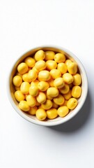 A bowl of yellow olives on a white surface, perfect for garnishing or serving with food