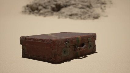 A vintage suitcase sits on golden sand, surrounded by vast desert. The sun illuminates its worn leather, showing signs of age. Nearby, a distant rocky formation adds to the desolate beauty.