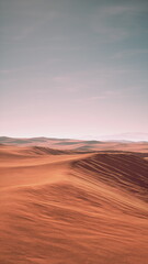The scene features a vast desert with gentle rolling sand dunes bathed in warm colors. The horizon blends with a soft sky, highlighting the beauty of this arid landscape at dusk.