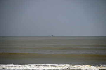 Mediterranean Beach at Tore del lago Puccini. Autumn sky with little sun. Reflections in water.