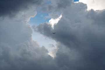 Small Airplane Flying Through Dramatic Storm Clouds