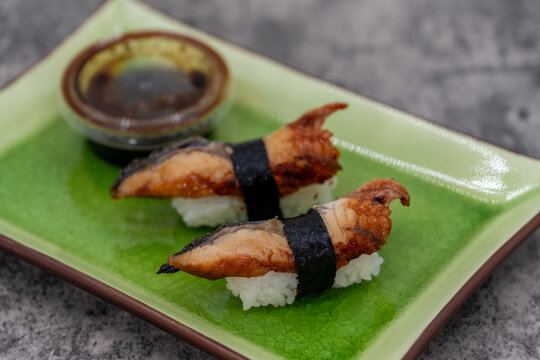 Sushi plate with a pair of freshwater eel nigiri as an appetizer for an Asian meal - Powered by Adobe