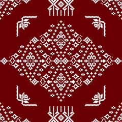 A detailed geometric pattern in white on a rich maroon background, featuring intricate designs and motifs.