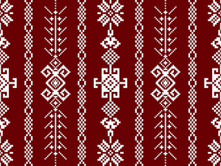 A repeating textile pattern featuring geometric designs in white on a rich red background, showcasing intricate motifs and decorative elements.