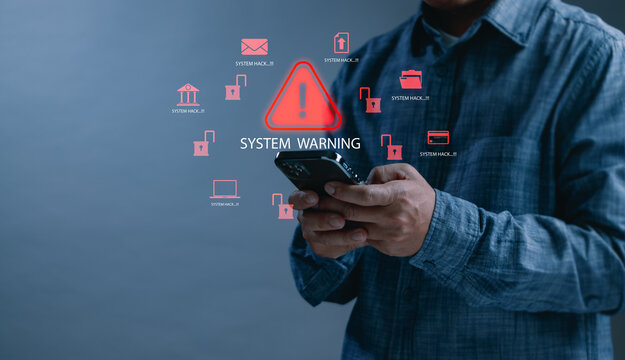 Man holding a smartphone with system warning and hacking alert icons. Concept of cybersecurity threat, data breach, malware attack, mobile phone vulnerability - Powered by Adobe