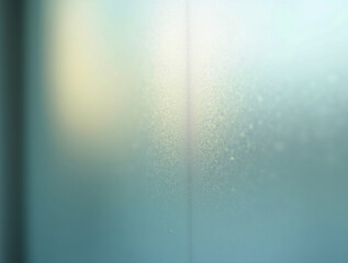 Abstract Frost Texture on Glass with Soft Teal and Yellow Light Gradient Creating a Cold Winter Background