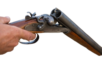 Hunter man in camouflage with a gun during the hunt in search of wild birds or game. Autumn hunting season.