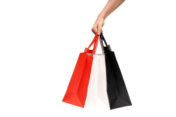 A person's hand holding a paper shopping bag with handles on a clean white background. Studio shot with ample copy space for text, logos, or branding. Isolated on white, cut out.