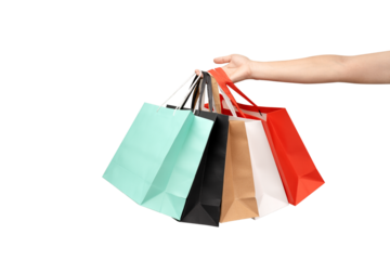 A person's hand holding a paper shopping bag with handles on a clean white background. Studio shot with ample copy space for text, logos, or branding. Isolated on white, cut out.