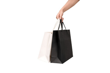 A person's hand holding a paper shopping bag with handles on a clean white background. Studio shot with ample copy space for text, logos, or branding. Isolated on white, cut out.