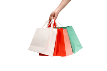A person's hand holding a paper shopping bag with handles on a clean white background. Studio shot with ample copy space for text, logos, or branding. Isolated on white, cut out.