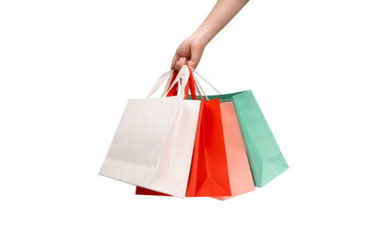 A person's hand holding a paper shopping bag with handles on a clean white background. Studio shot with ample copy space for text, logos, or branding. Isolated on white, cut out.