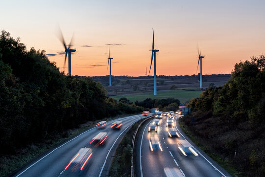 Wind turbines and highway traffic creating renewable energy concept
