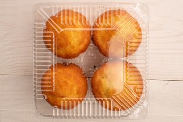 Delicious muffins  on a wooden table, top view, close-up.