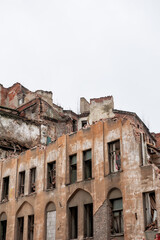 Crumbling facade of abandoned urban building shows layers of decay