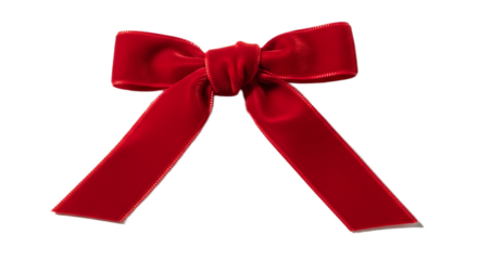 A single red velvet bow with a knot in the center against a black background in a studio shot