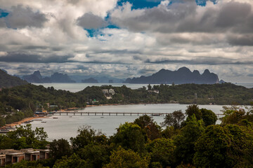 Beautiful marine nature of Thailand. Waves on the ocean. Green tropical island. Blue clear sky.	
