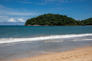 Beautiful marine nature of Thailand. Waves on the ocean. Green tropical island. Blue clear sky.	
