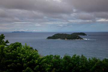 Beautiful marine nature of Thailand. Waves on the ocean. Green tropical island. Blue clear sky.	
