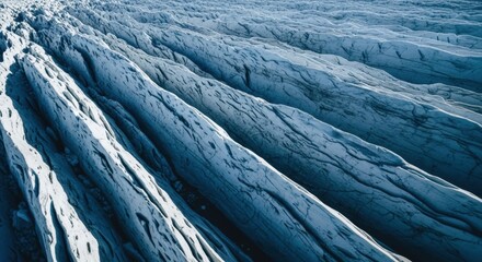 Glacial ice texture with deep blue shadows. Abstract natural pattern of a frozen landscape. Climate change and global warming concept. Environmental science and geology theme. Arctic winter surface