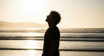 Silhouette of a male adult on the beach at sunset. Contemplation and mindfulness concept. Personal growth and spiritual journey. Finding peace and solitude in nature. Hope for the future
