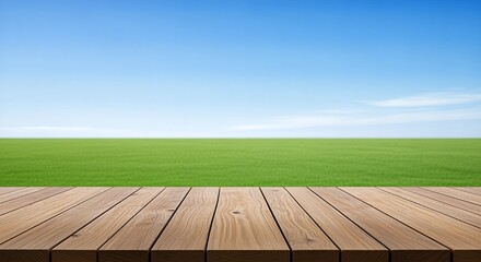 Wooden Deck Overlooking a Green Field Under a Blue Sky.