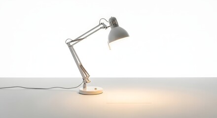 A white adjustable desk lamp illuminating a white surface against a white background studio shot