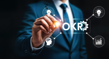A businessperson is writing okr objectives and key results on a virtual screen, representing a framework for defining and tracking objectives and outcomes in an organization