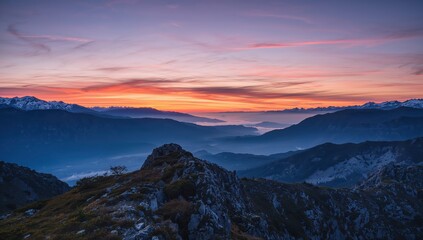 Stunning sunset over majestic mountain range with vibrant colors and serene atmosphere, perfect for travel and adventure