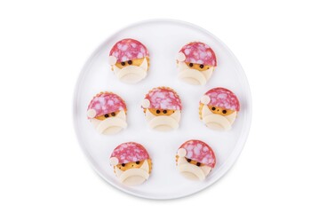 Salami sausage and cheese slices and crackers in the form of Santa Claus for Christmas holidays on a white isolated background
