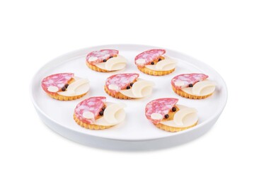 Salami sausage and cheese slices and crackers in the form of Santa Claus for Christmas holidays on a white isolated background