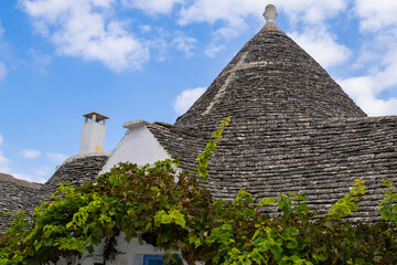 Traditional trulli houses.  Conical roofs made of stone slabs. Alberobello, province of Bari, Puglia region, Italy