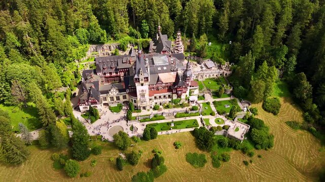 Long queue in front of the entrance to the beautiful castle. Aerial perspective on the spectacular Peles Castle, Prahova County, Romania.