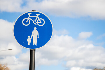 Blue circular sign indicating a shared pedestrian and cycle path in the UK, promoting safe walking and cycling routes.