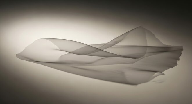 Flowing fabric creates an abstract and elegant texture with soft light and shadows in a monochrome palette evoking a sense of calm and sophistication perfect for backgrounds or design elements.