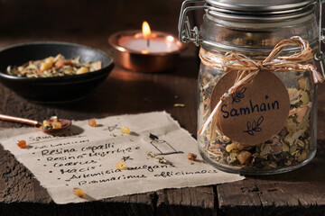 Incense mixture for Samhain in a jar on wooden table, autumn still life, moody atmosphere