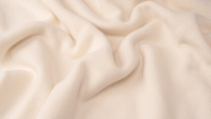 Obraz premium Soft milky color merino wool sweater texture as a background.