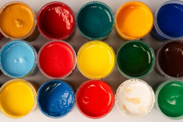 Gouache colorful paints set. Jars of gouache paint isolated on a white background.