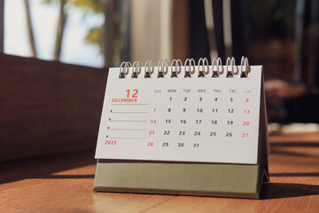 2025 calendar page, December, the last month of the year on table, with copy space. concept of planning and scheduling important appointments before end of the year.