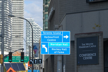 Fototapeta premium looking east on Harbour St at Bay St to traffic signs and directions including Westin Harbour Castle Conference Centre sign at 11 Bay St, Toronto