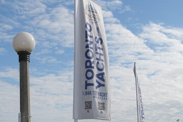Fototapeta premium Toronto Yachts (a boat rental service) banners on a cloudy blue sky 