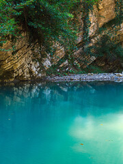blue lake and cliffs high in the mountains