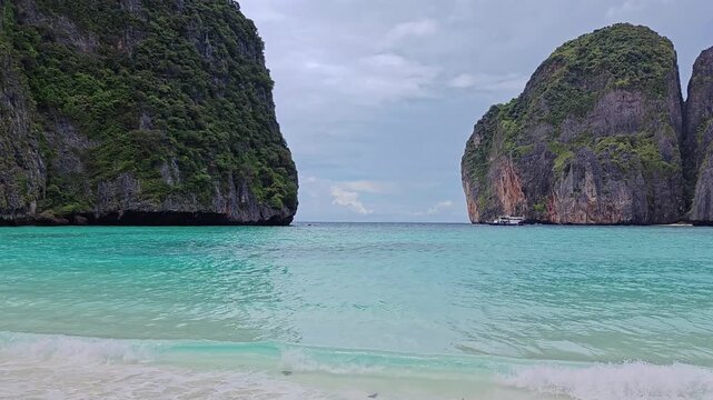 Maya Bay is a famous bay on the island of Koh Phi Phi Leh, Thailand. Cristal Clear Blue and turquoise water in lagoon