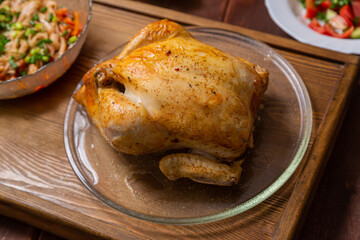 Couscous with dried fruits and turmeric, baked whole chicken flatbread, and vegetable salad