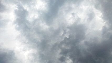 Dramatic dark gray clouds covering the sky before a heavy storm. Overcast, moody, and powerful weather background with copy space. Perfect for abstract, climate change, or stress concepts.